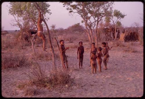 Children playing at a curing dance, girls clapping and singing and the boys dancing like the men