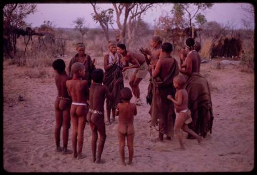 People in a circle, clapping and dancing