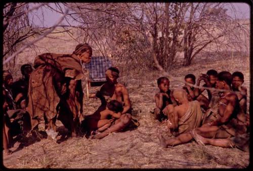 Women and children sitting at expedition camp