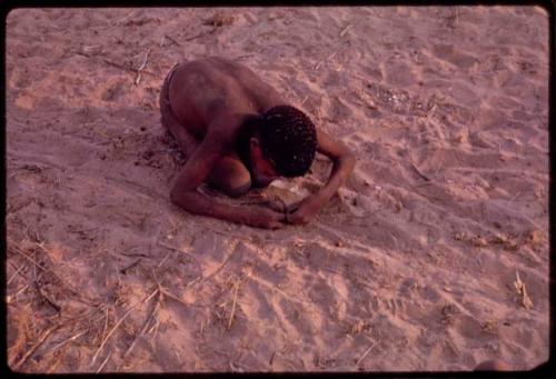 Boy leaned over playing with a toy "auto"