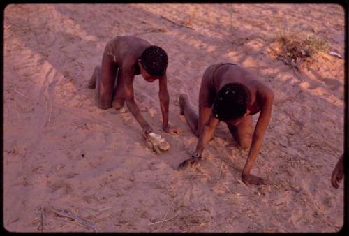 Two boys making and playing with toy "autos"