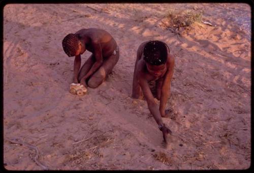 Two boys making and playing with toy "autos"