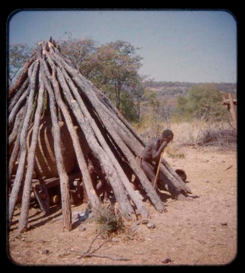 Meri coming out of Mukolovandi's storage hut