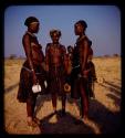 Three women standing, wearing Vahimba headdresses