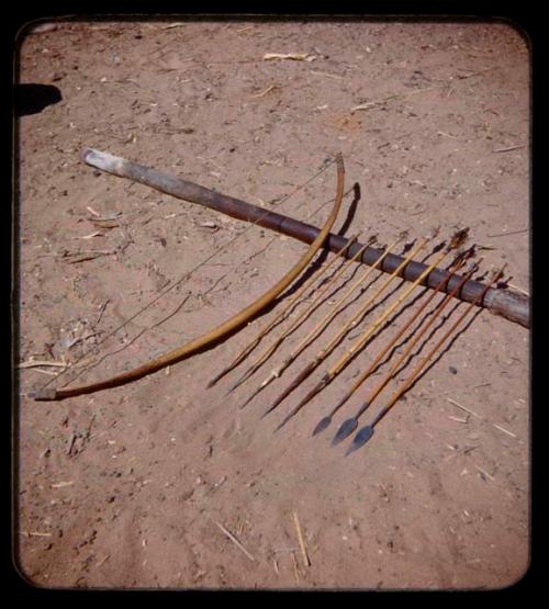 Arrows and a bow resting on a stick