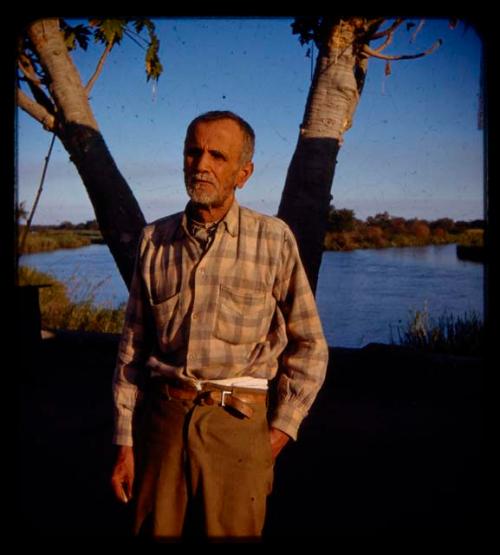 Senhor Jaoa Marcelino standing by a tree