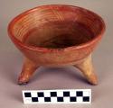 Ceramic tripod bowl, red on orange, incised interior