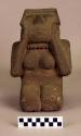 Ground stone effigy,  kneeling female clasping face, rough