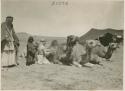 Life scene close shot of men child and camels