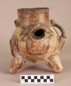 Large tripod pottery vessel with adorno