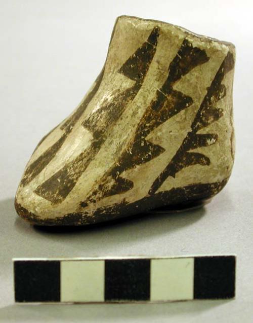 Brown on white pottery shoe