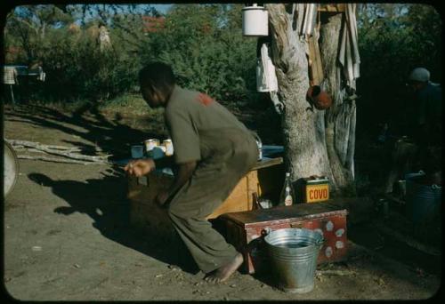 Expedition member standing up in the camp cooking area