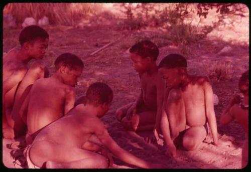 Boys playing /Ui (the counting game) in the sand