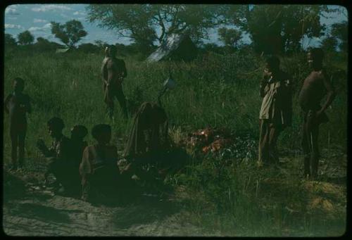 Group of people gathered, with an expedition tent in the background