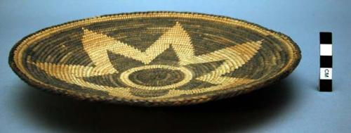 Basketry plate, coiled. Made of yucca, bear grass, devil's claw. Star in center