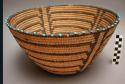 Flared bowl basket, coiled. Beaded. Geometric designs.