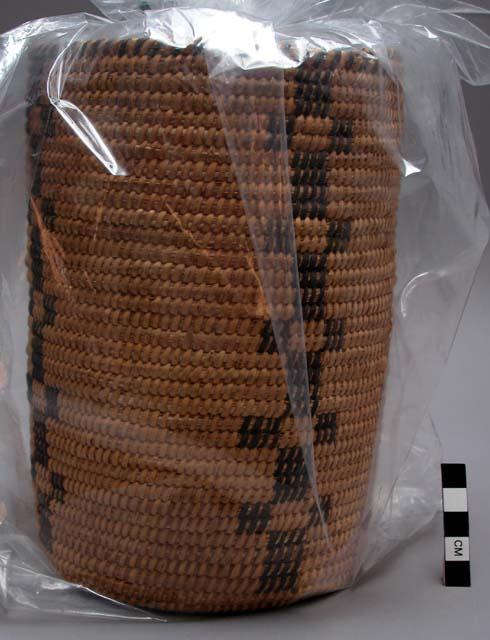 Cylindrical basket, coiled. Geometric designs.