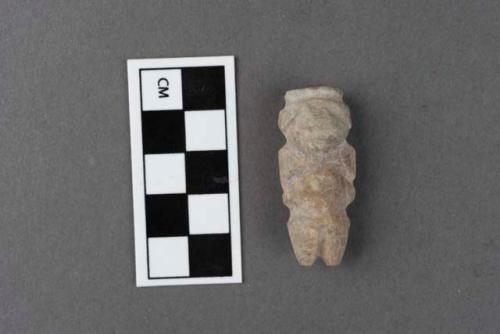 Small rude stone effigy of human figure