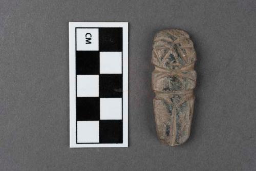 Small rude stone effigy of human figure