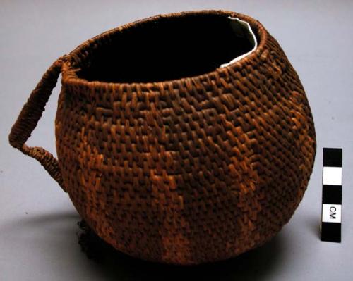 Coarse weave basket bowl with globular shape. radiating pattern.