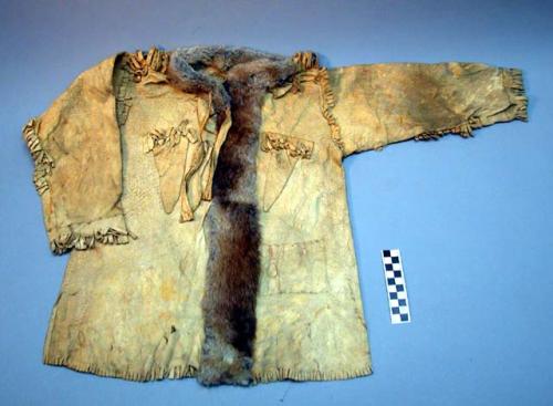 Boy's buckskin shirt. Fringed bottom, shoulders and below arms. Split front.