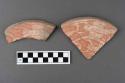 Pink and white shallow pottery dish with animal incised on bottom (out).