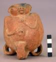 Unpainted pottery jar - head & arms in relief, animal in relief on back, 3 band