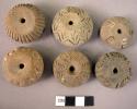 Pottery spindle whorl with incised designs