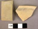 Rim potsherd; handle fragment - slipped and well polished