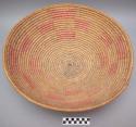 Basket tray, coiled. Made of bear grass (natural and dyed pink).