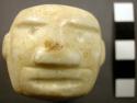Large jade ring, carved face on one side.  Very light green jade.