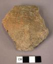 10 potsherds with irregular incised line decoration; some with legs