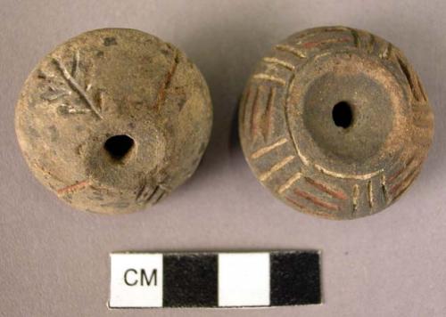 2 pottery spindle whorl with incised and colored designs