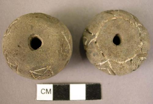 2 pottery spindle whorl with incised and colored designs