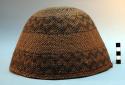 Twined basket hat. 2 broad bands of design in darker color, one at rim