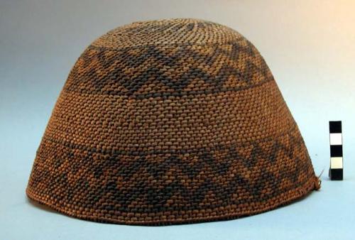 Twined basket hat. 2 broad bands of design in darker color, one at rim