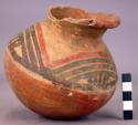 Pottery jar, red base with black and red ornament on upper yellow zone