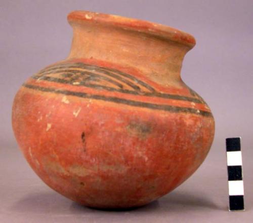 Pottery jar, red base with black and red ornament on upper yellow zone