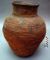 Basket, 3 rod coiled, olla shaped. Tapered base w/ wide body. Narrow shoulder