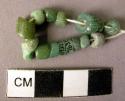 14 small green glass beads