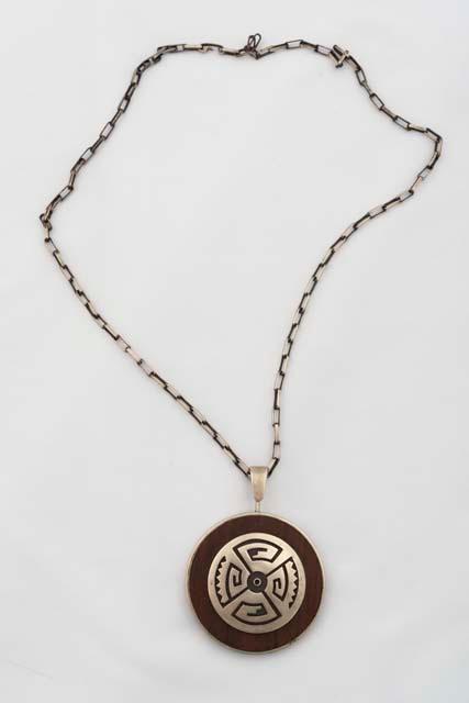 Pendant of silver overlay mounted on wood, on silver chain