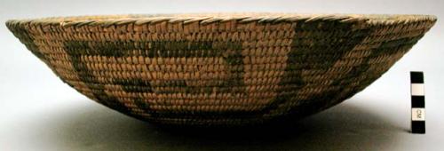 Bundle coiled basket. Bowl shaped. Center of basket is solidly dark.