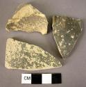 5 potsherds, 1 base fragment, all black urfirnis ware, dull on thick powdery cla