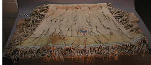 Woman's caribou skin dress (2 pieces). Fastens at neck with thongs. Fringed.