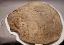 Sioux pemmican bowl. Made from bison hide. Some fur remains on exterior. Cut in