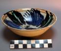 Ceramic bowl, blue, purple, green, brown glaze on cream int, horse at center