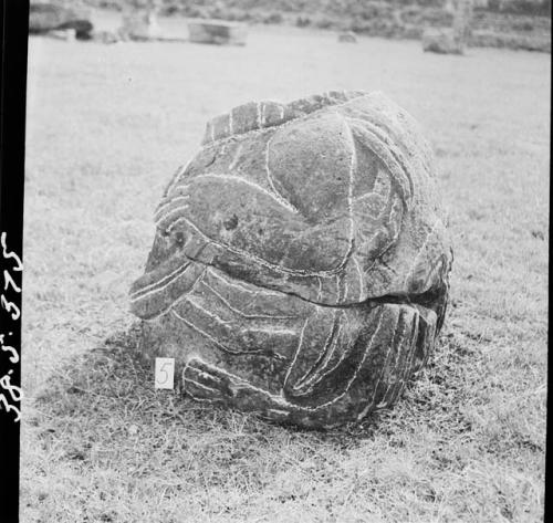 Stone figure (head missing) deliniated upon a boulder (Back and left side)