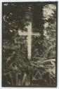 Photograph of cross among trees