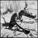 "Gao Helmet" shaping an assegai blade, with his second wife //Kushay sitting next to him watching