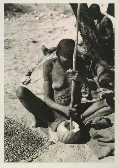 /Twikwe putting tsama melon seeds on sieve and in a bowl